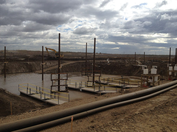 Pump, platforms and walkways in Oil mining tailings pond inAlberta Canada